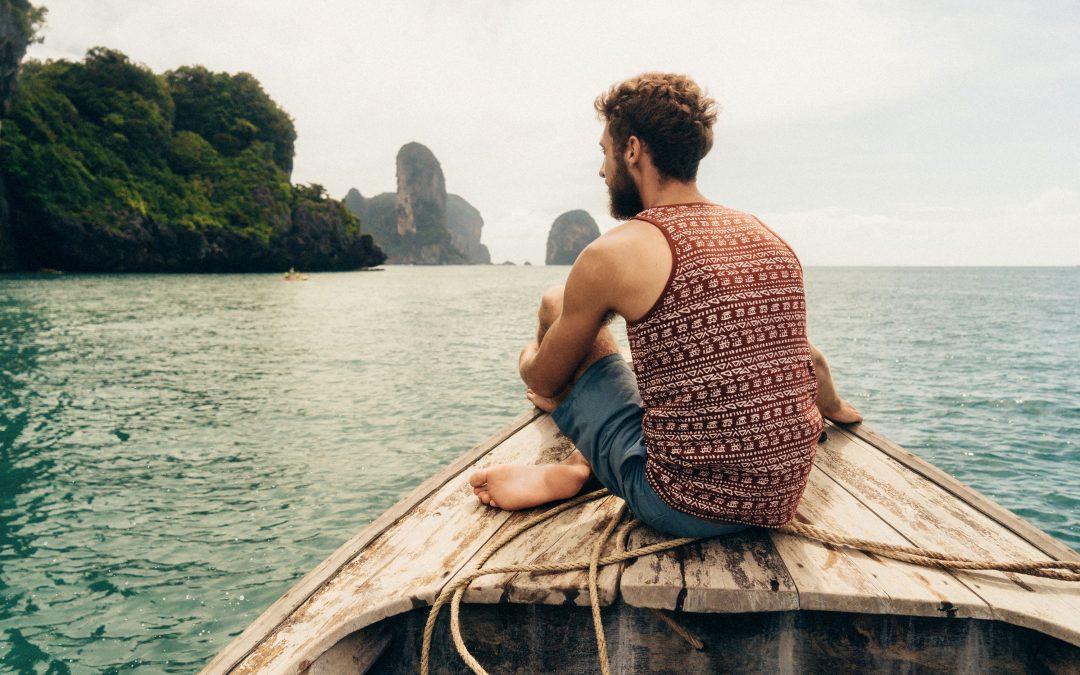 Travel Explorations - Man sitting on a boat