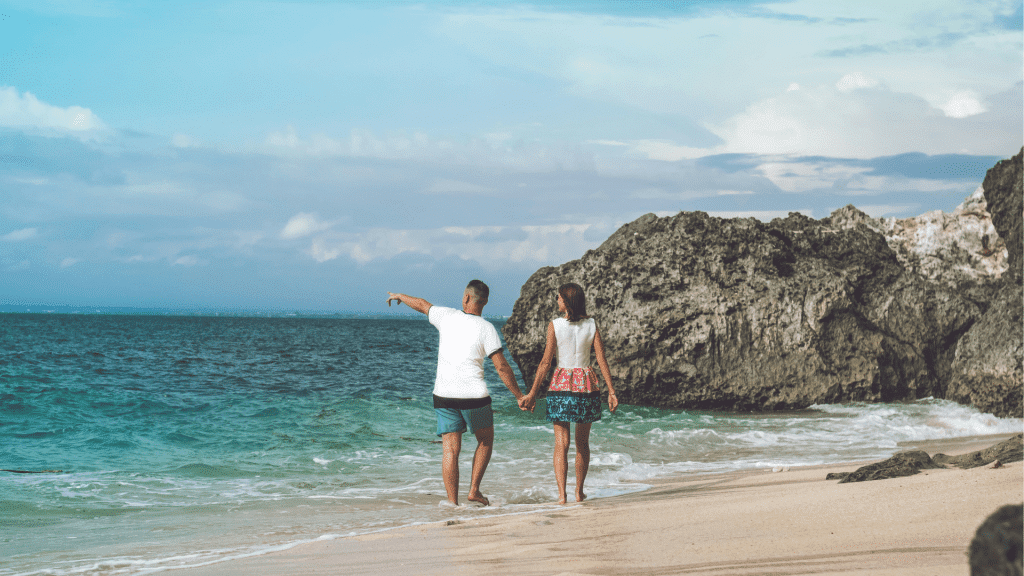 Couple walking on a tropical beach - Romance Travel Exclusive Offer