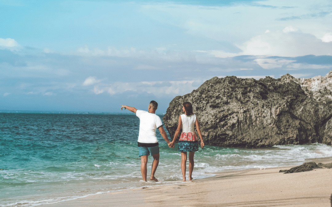 Couple walking on a tropical beach - Romance Travel Exclusive Offer